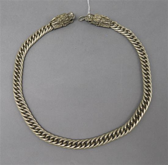 A Chinese white metal necklace with dragon head clasps